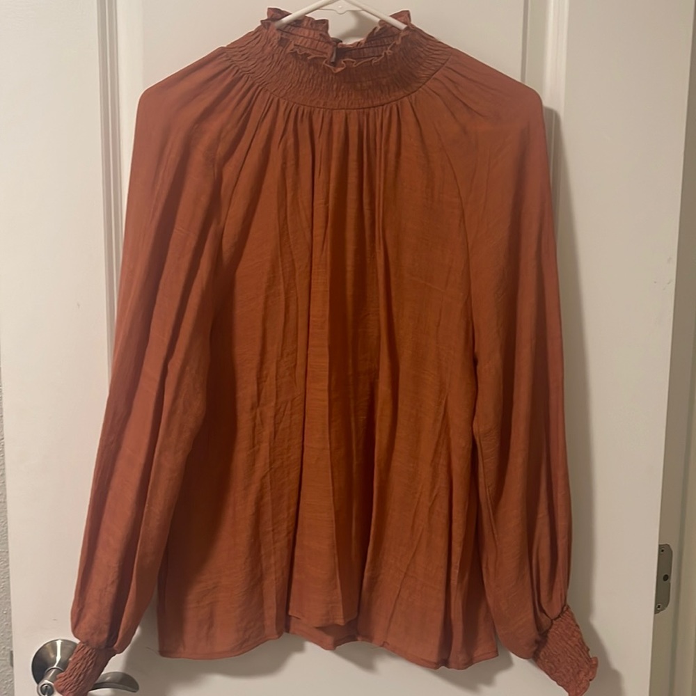 Orangish sheer blouse, high neck, Wood detail buttons on back of neck. Med size